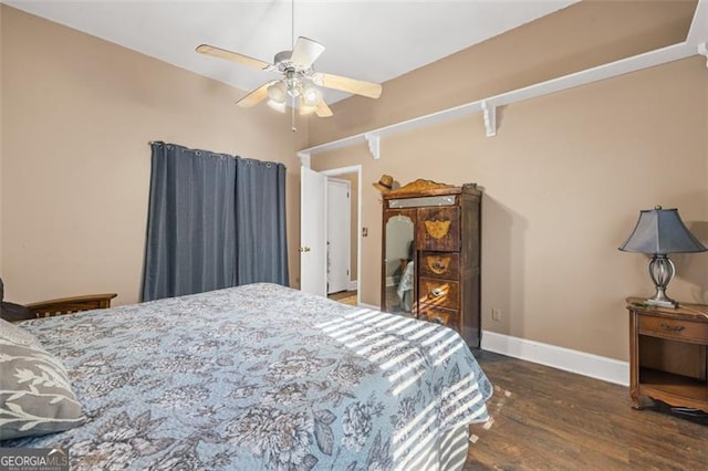 bedroom with ceiling fan, baseboards, and wood finished floors