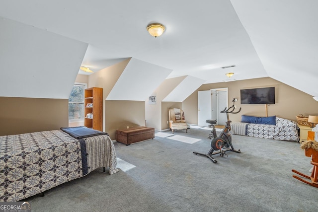 bedroom with lofted ceiling, carpet floors, and visible vents