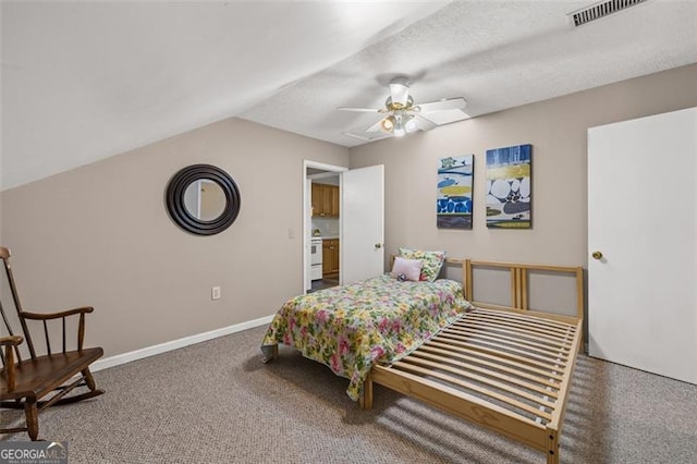 carpeted bedroom with baseboards, visible vents, vaulted ceiling, and a ceiling fan