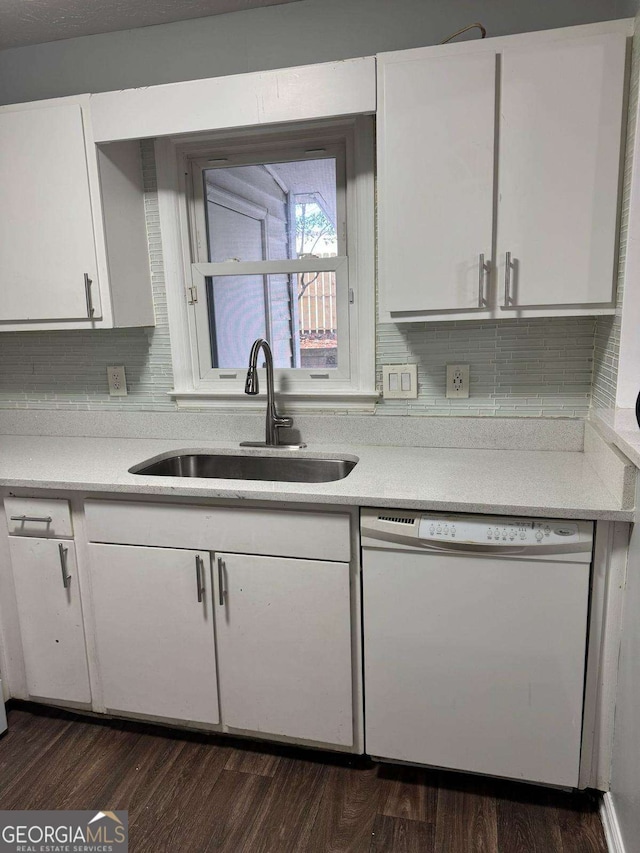 kitchen with dishwasher, light countertops, a sink, and white cabinetry