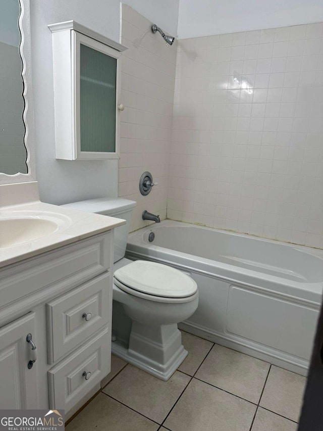 bathroom with toilet, tub / shower combination, vanity, and tile patterned floors