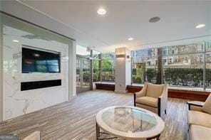 interior space featuring a fireplace, wood finished floors, and recessed lighting