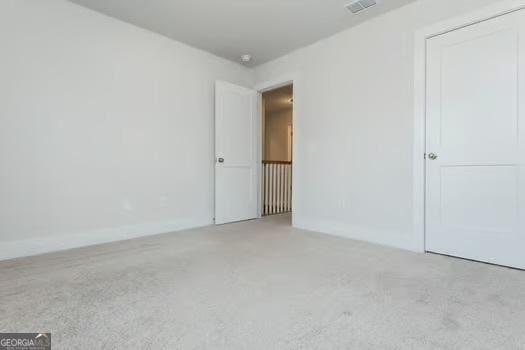 unfurnished bedroom with visible vents