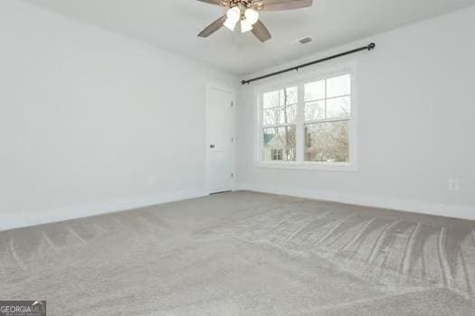 spare room featuring carpet floors and a ceiling fan