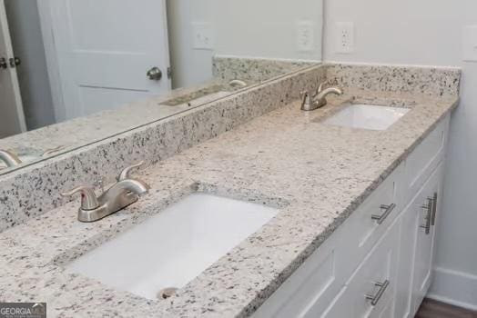 full bathroom featuring double vanity and a sink