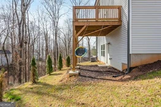 view of yard with a carport and a wooden deck