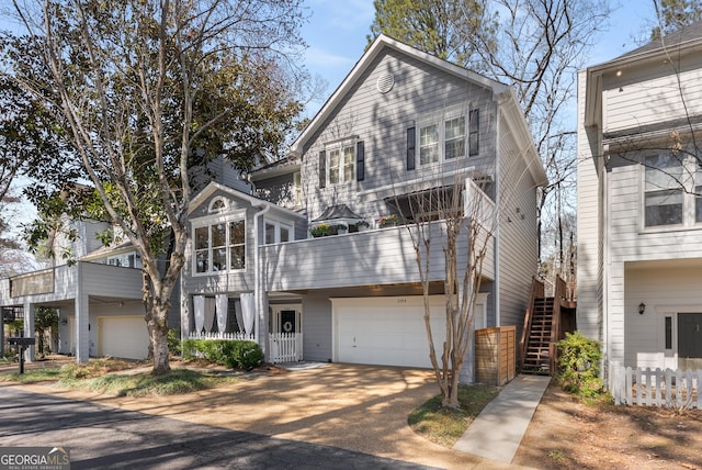 view of front of house with stairs, a garage, and driveway