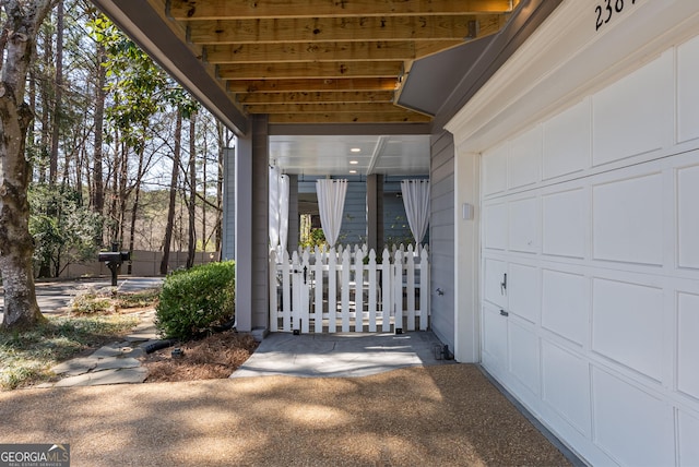 view of exterior entry with a garage and driveway