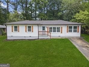 single story home with a front lawn and concrete driveway