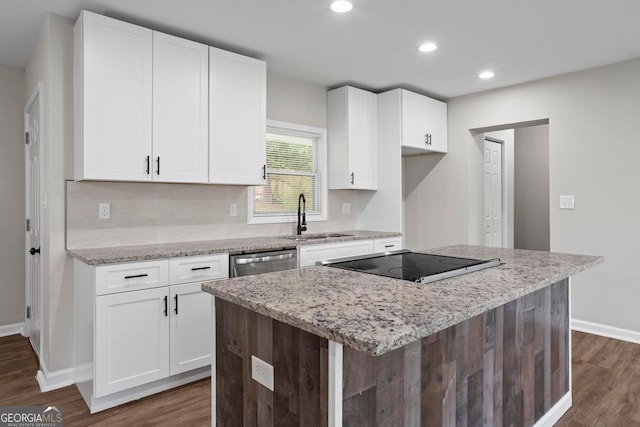 kitchen with a sink, white cabinets, dark wood-style flooring, and black electric cooktop
