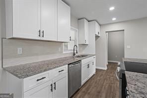 kitchen with stainless steel appliances, a sink, light stone countertops, and white cabinets