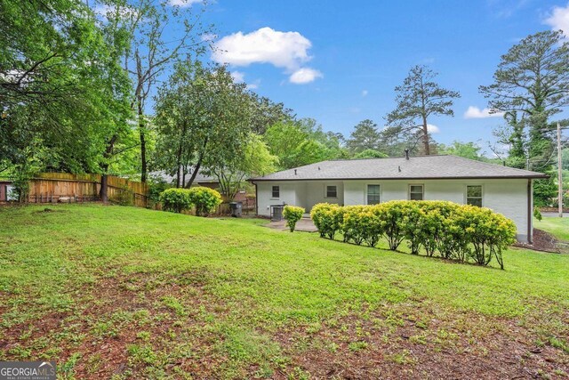 exterior space with fence and a yard