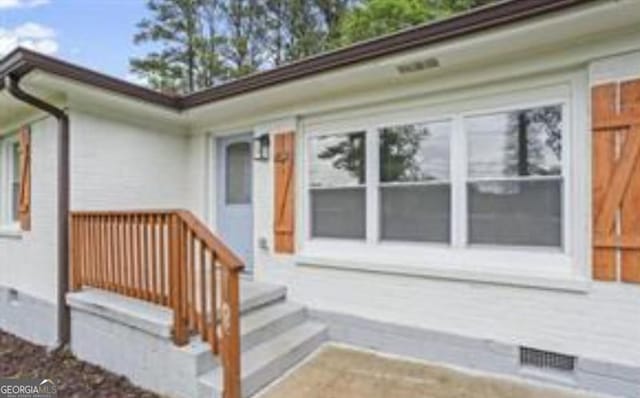 doorway to property with visible vents and crawl space