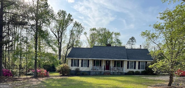 219 Loblolly Dr, Swainsboro, GA 30401 - view of front of house with a chimney, a porch, and a front lawn