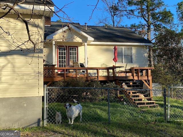 view of front of home with a deck, fence, and a gate