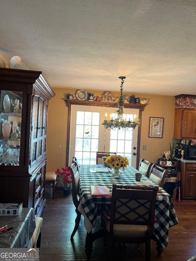 219 Loblolly Dr, Swainsboro, GA 30401 - dining area featuring dark wood-style flooring, a textured ceiling, and a chandelier