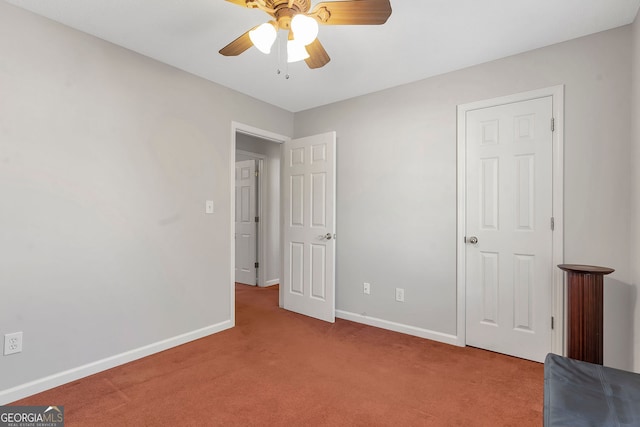 unfurnished bedroom with light carpet, ceiling fan, and baseboards