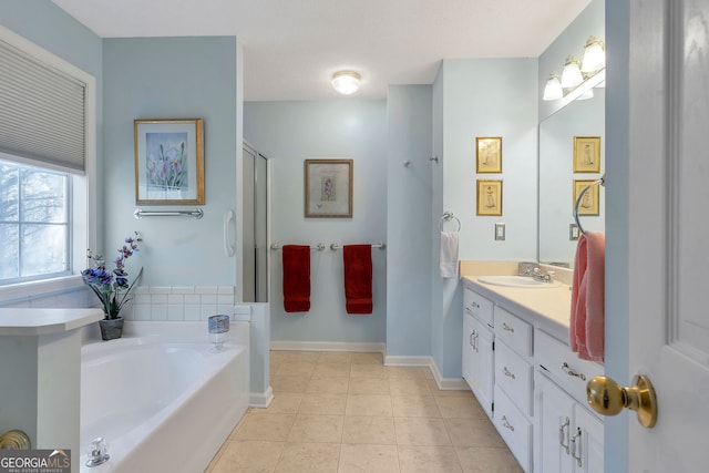 bathroom with baseboards, a garden tub, vanity, and tile patterned floors