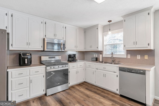 kitchen featuring white cabinetry, appliances with stainless steel finishes, and a sink