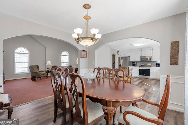 dining room with a chandelier and wood finished floors