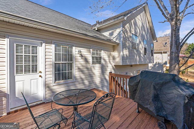 deck featuring outdoor dining area and area for grilling