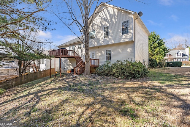 back of house featuring stairs, fence, and a wooden deck