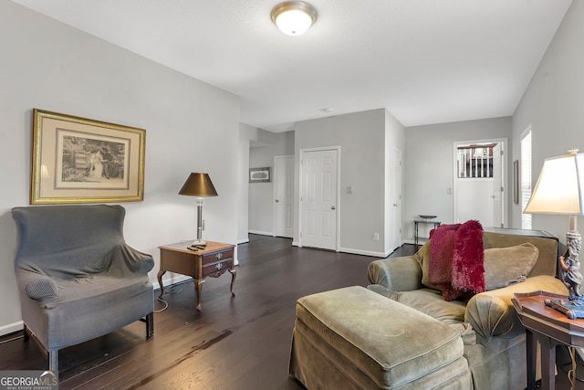 living area featuring dark wood-style floors and baseboards