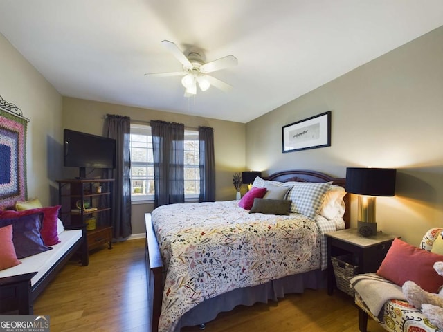 bedroom with a ceiling fan and wood finished floors