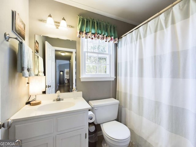 bathroom with a shower with curtain, vanity, toilet, and crown molding