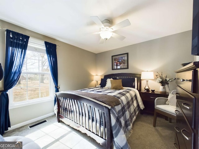 carpeted bedroom with baseboards, visible vents, and ceiling fan