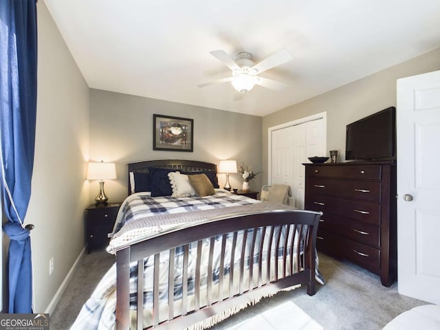 bedroom with a ceiling fan, baseboards, a closet, and light colored carpet