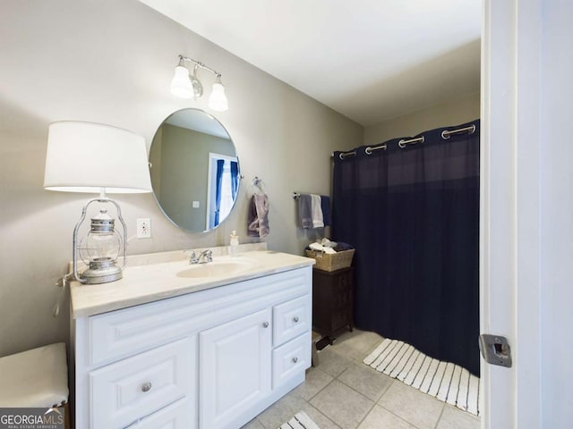 bathroom with a shower with shower curtain, vanity, and tile patterned floors