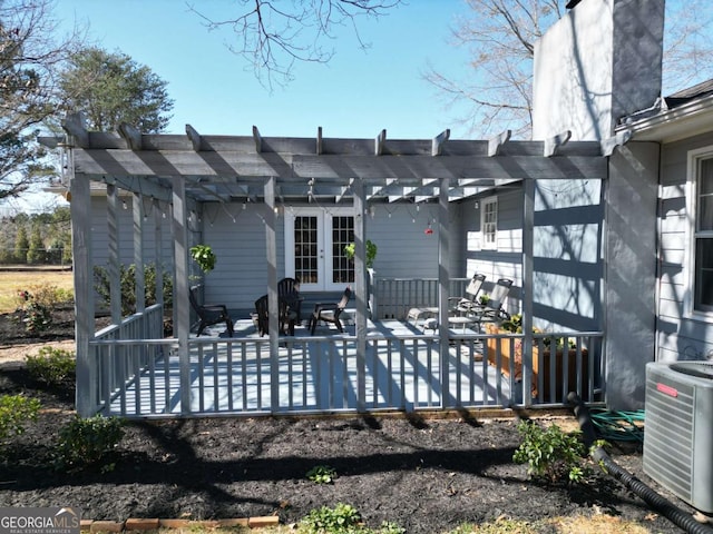 rear view of house featuring central AC unit, a pergola, and french doors