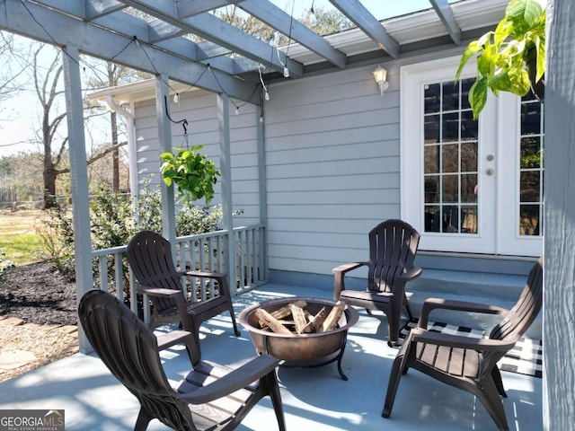 view of patio with an outdoor fire pit and a pergola