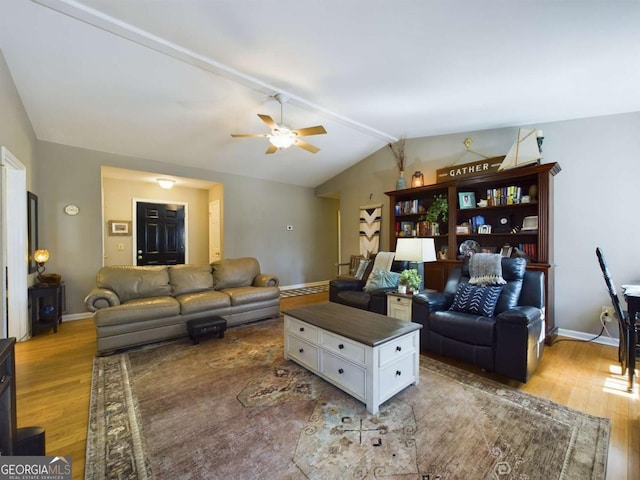 living room with a ceiling fan, vaulted ceiling, baseboards, and wood finished floors