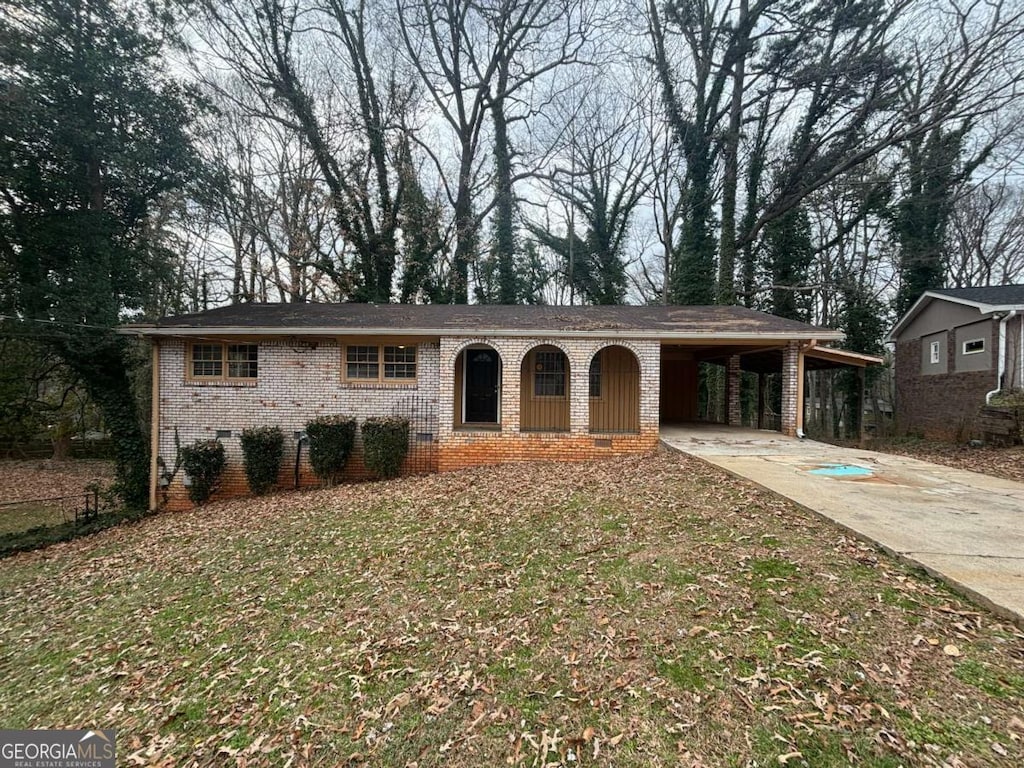 ranch-style home featuring concrete driveway, an attached carport, crawl space, fence, and brick siding