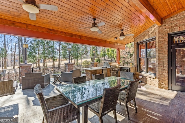 view of patio / terrace featuring exterior kitchen, outdoor dining space, and grilling area