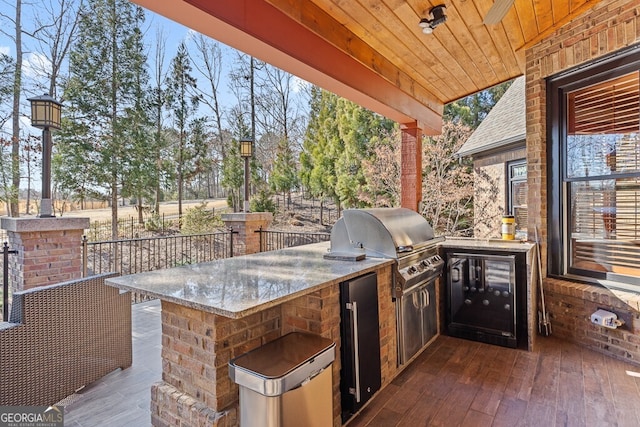 view of patio / terrace featuring a grill and exterior kitchen