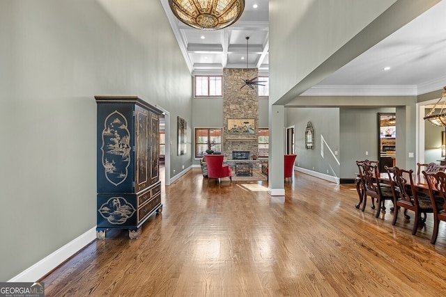 entryway with a fireplace, baseboards, and wood finished floors