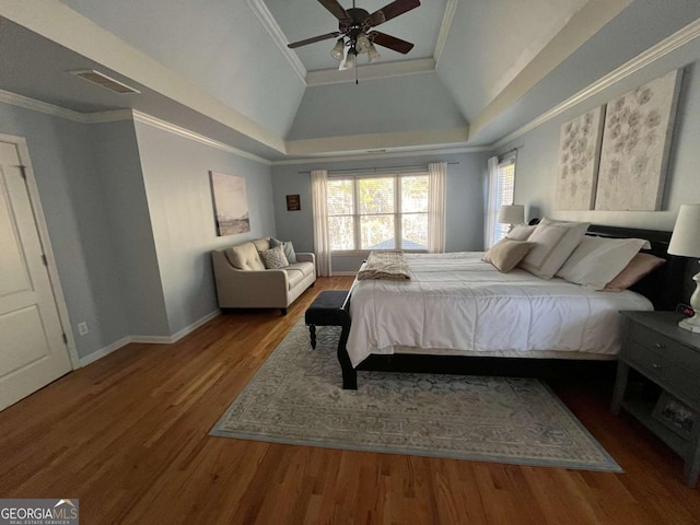 bedroom with visible vents, ornamental molding, ceiling fan, and wood finished floors