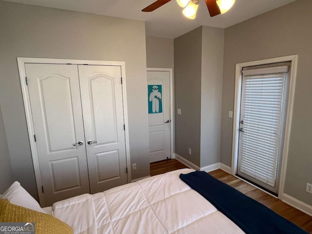 bedroom with a ceiling fan, a closet, baseboards, and wood finished floors