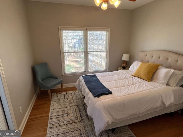 bedroom featuring baseboards and wood finished floors