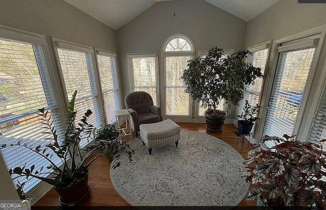 sitting room with vaulted ceiling and wood finished floors