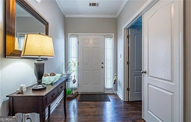 foyer with ornamental molding, dark wood-style flooring, and visible vents