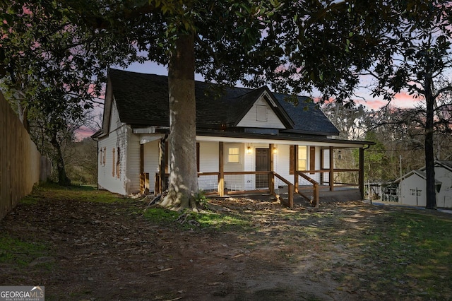 view of front of house with a porch and roof with shingles