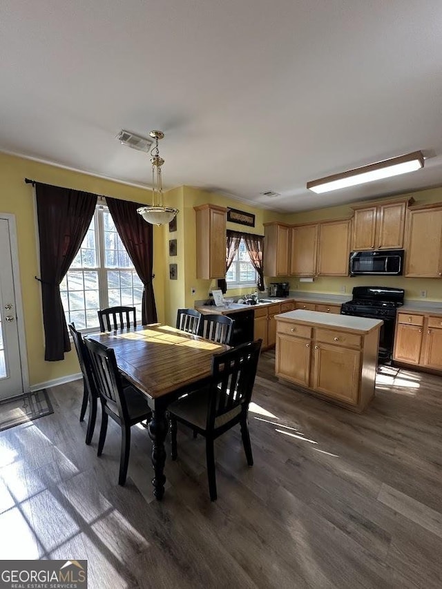 dining room featuring baseboards, visible vents, and dark wood finished floors