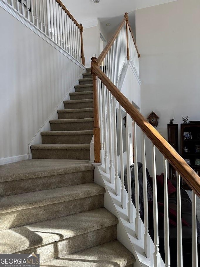 stairs featuring a towering ceiling