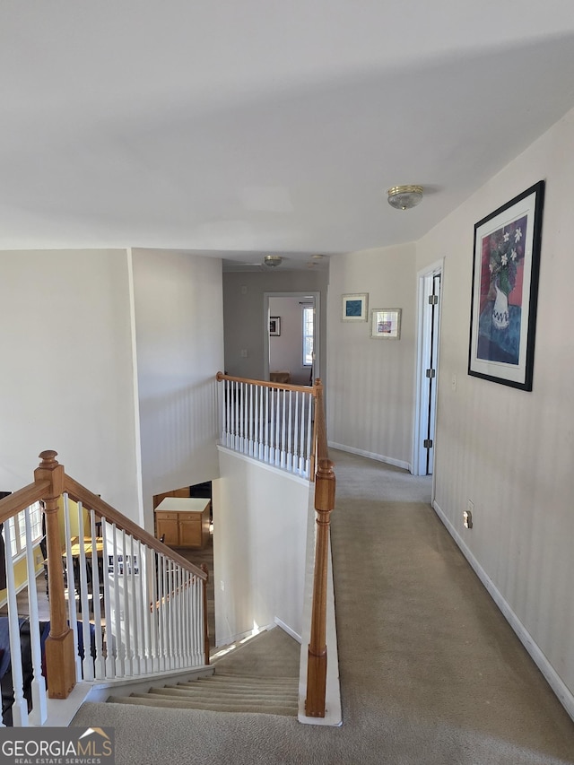 stairs with carpet floors and baseboards