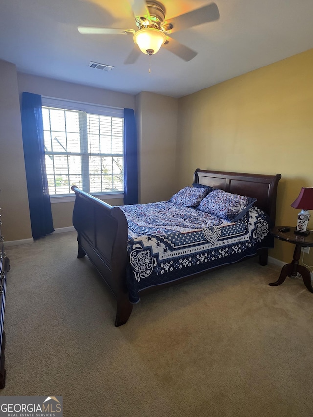 bedroom featuring ceiling fan, carpet floors, visible vents, and baseboards