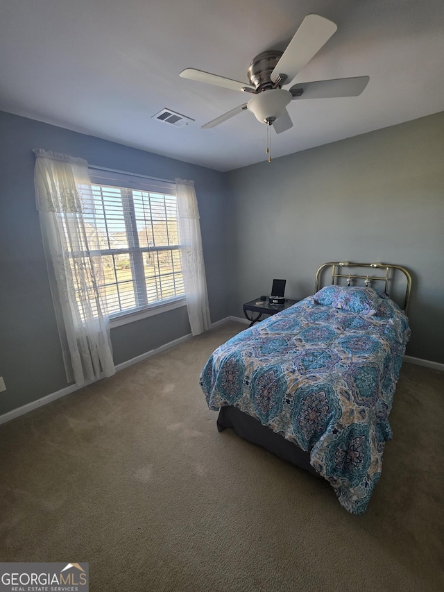 bedroom featuring carpet floors, baseboards, visible vents, and a ceiling fan